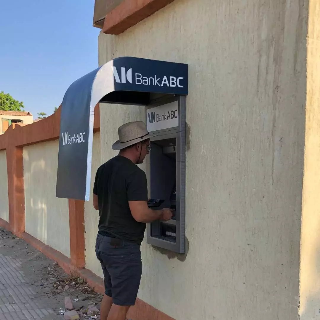 Withdrawing cash from ATM in Africa Zambia - Victoria Falls - Devil's Pool