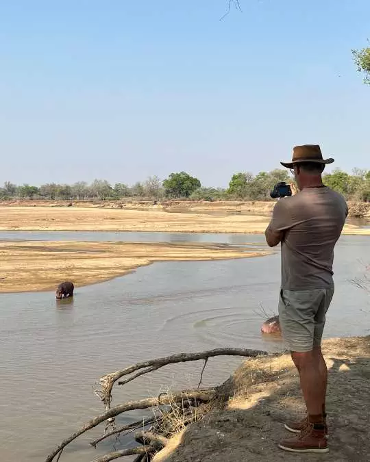 Nanan Travel - Balancing Luxury & Wilderness in African Safaris _ Ultimate Guide (8) Nanan Travel - Balancing Luxury & Wilderness in African Safaris _ Ultimate Guide-viewing hippopotomus from lodge deck