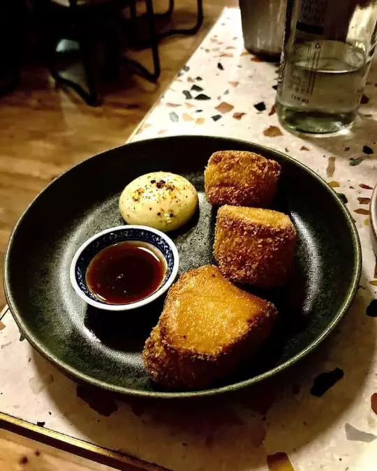 Cape Town’s Culinary Crown_ Five Restaurants Worth the Journey - Bao down (3) Nanan Travel - Balancing Luxury & Wilderness in African Safaris _ Ultimate Guide-clients on a safari-honeymoon